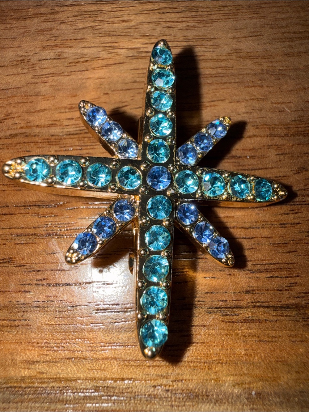 Gold-Tone Starburst Brooch with Aqua and Blue Crystals